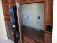 Swing-out back in Entertainment Center for large plasma TV creates cavity to hide wires.